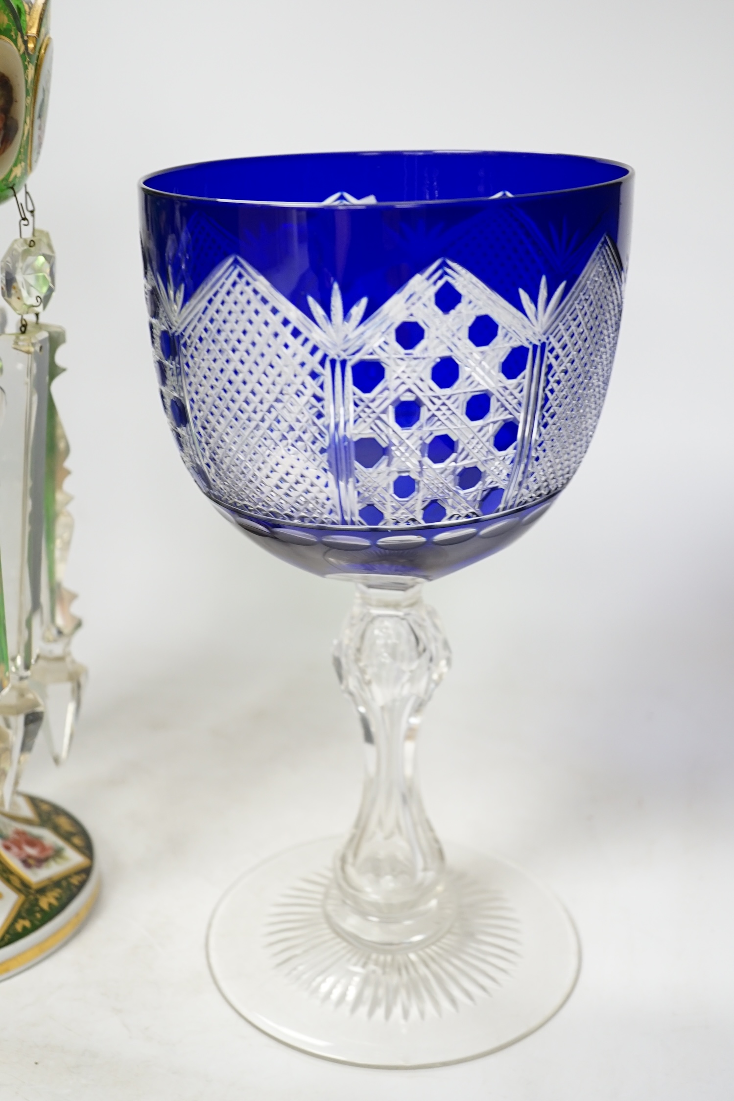 A 19th century Bohemian green glass overlaid cut glass lustre with drops together with an oversized goblet, largest 35cm high. Condition - goblet, good. Lustre, fair